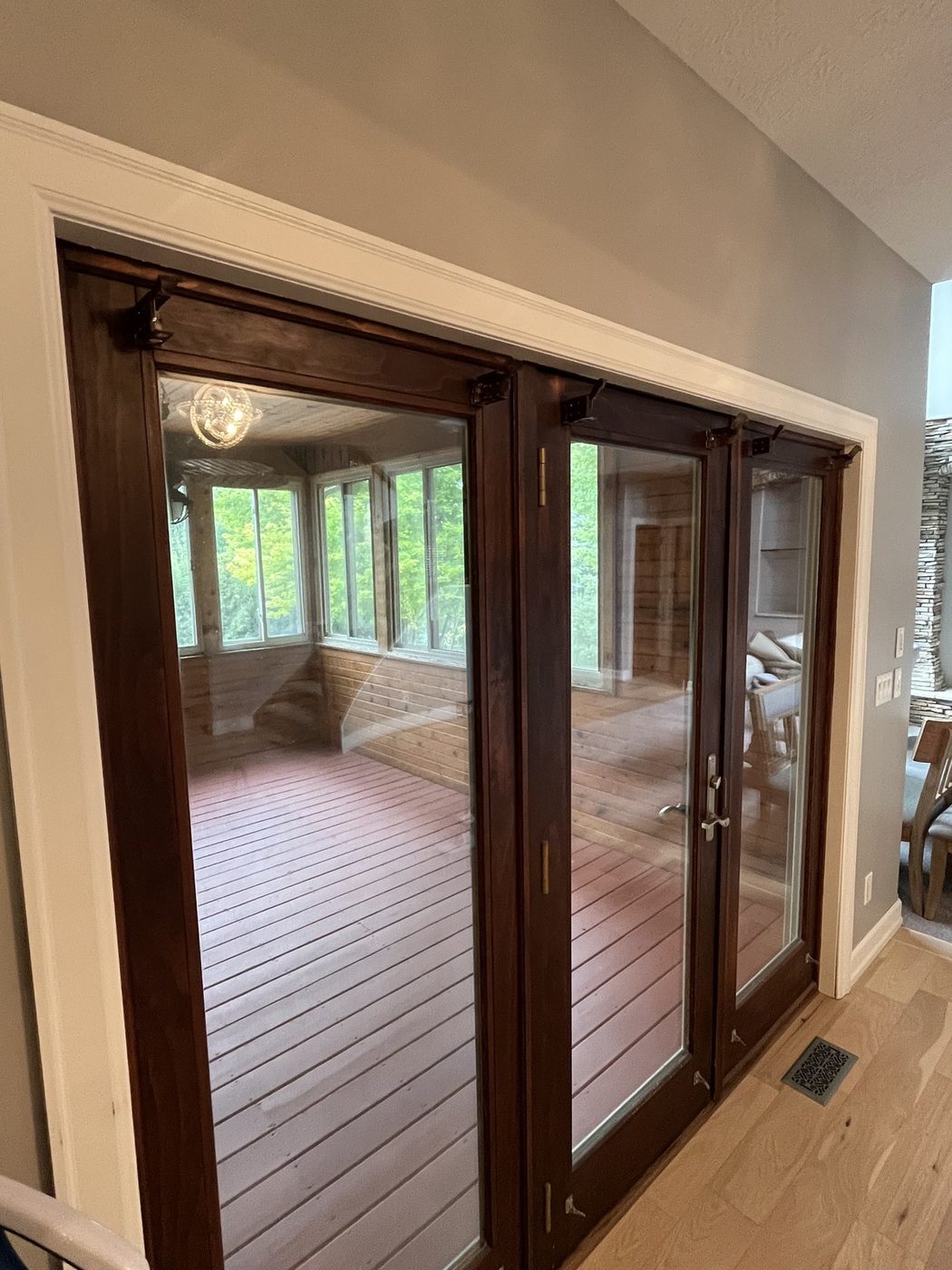 Interior wood french doors and hardwood floor in a finished room